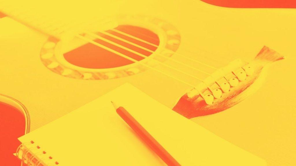 Mikä on Teosto -artikkelikuva, kitara, tyhjä muistilehtiö ja kynä